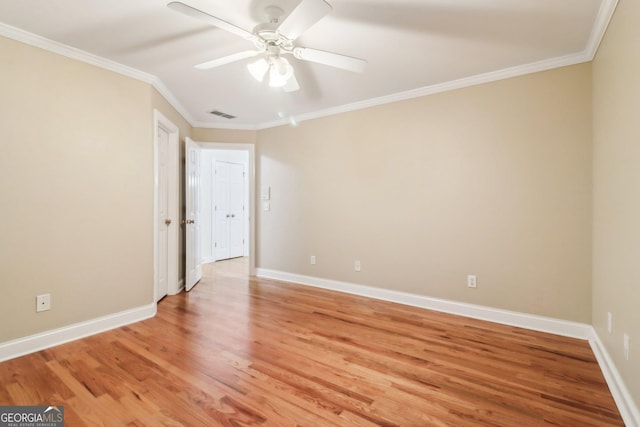 unfurnished room with hardwood / wood-style flooring, ceiling fan, and ornamental molding