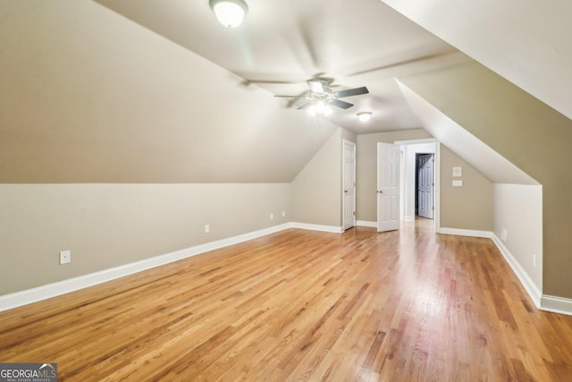 additional living space with ceiling fan, light wood-type flooring, and vaulted ceiling