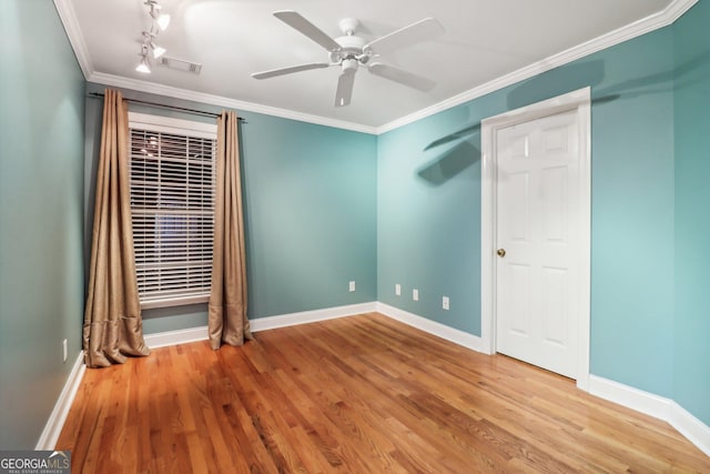 unfurnished bedroom featuring hardwood / wood-style flooring, ceiling fan, and ornamental molding