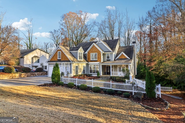 view of front of home with covered porch and a garage