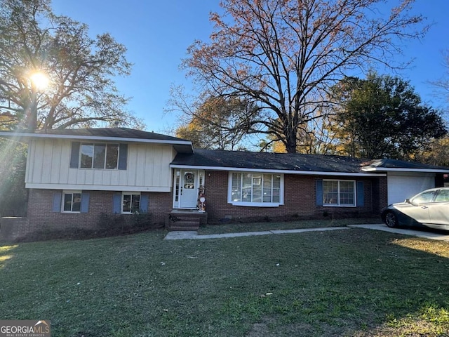 split level home featuring a front lawn and a garage