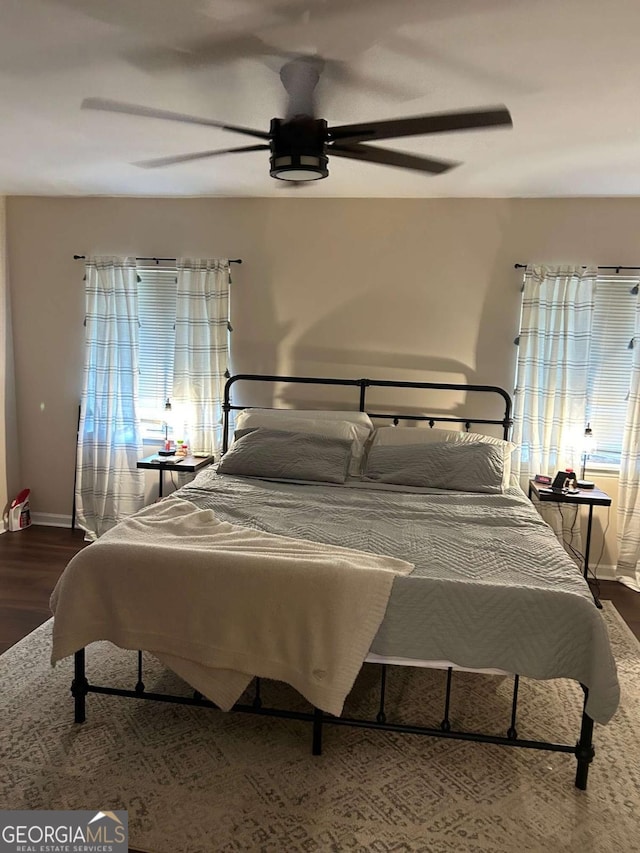 bedroom with hardwood / wood-style flooring and ceiling fan