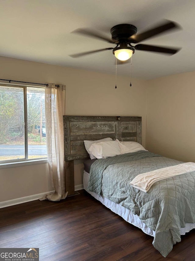 bedroom with ceiling fan and dark wood-type flooring