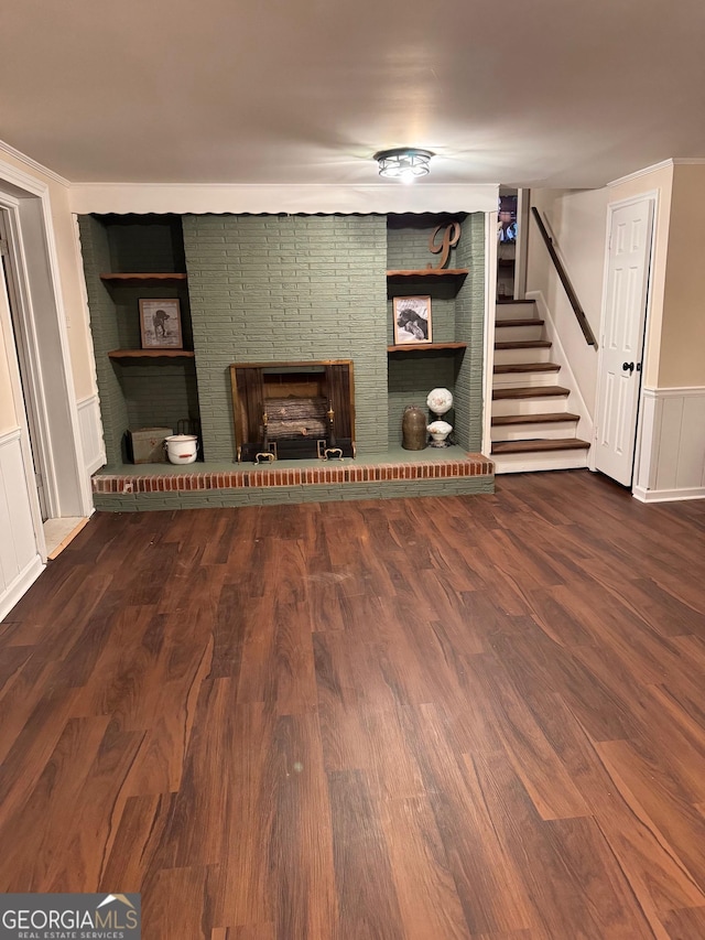 unfurnished living room featuring dark hardwood / wood-style floors, built in features, and a fireplace