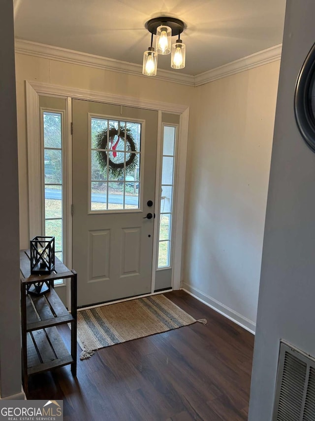 foyer entrance featuring dark hardwood / wood-style flooring and ornamental molding