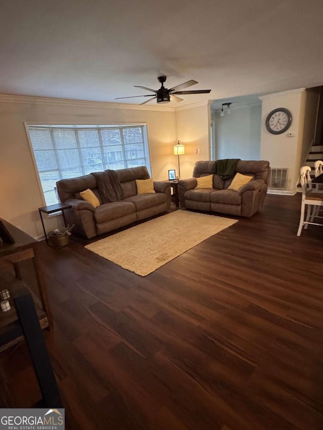 unfurnished living room featuring ceiling fan, crown molding, and dark wood-type flooring