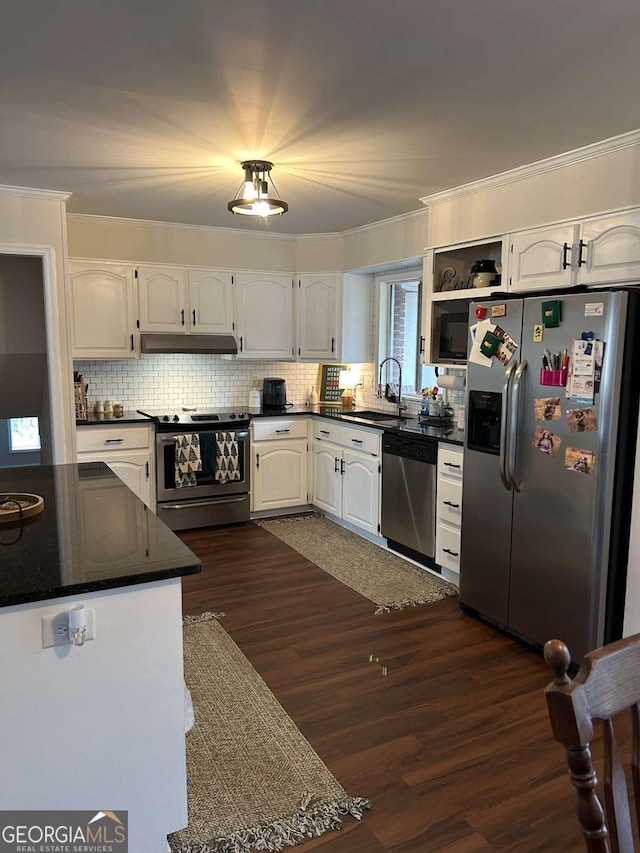 kitchen featuring appliances with stainless steel finishes, dark hardwood / wood-style flooring, white cabinetry, and sink