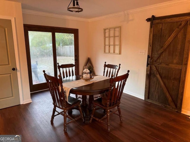 dining space featuring a barn door, dark hardwood / wood-style flooring, and crown molding