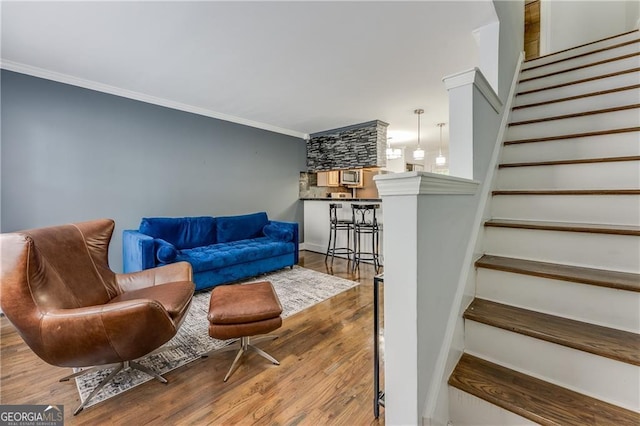 living room featuring ornamental molding and hardwood / wood-style flooring