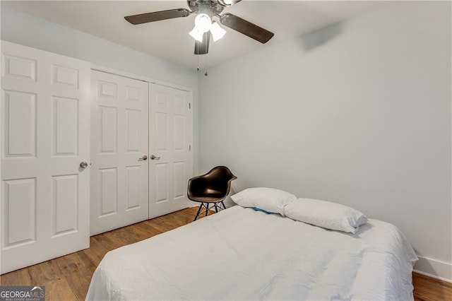 bedroom with ceiling fan, a closet, and hardwood / wood-style flooring