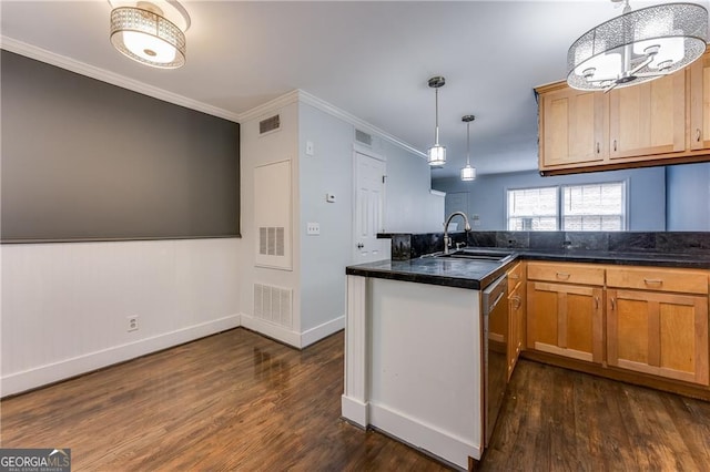 kitchen with dark wood-type flooring, sink, hanging light fixtures, and kitchen peninsula