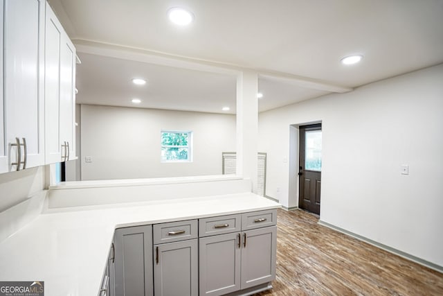 kitchen featuring gray cabinetry and hardwood / wood-style floors