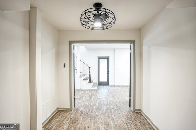 corridor with french doors and hardwood / wood-style floors