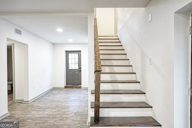 stairway featuring hardwood / wood-style floors