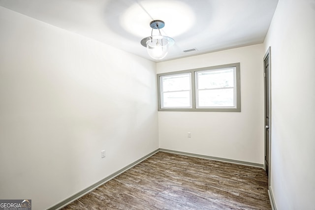 empty room featuring dark wood-type flooring