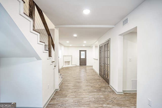 hall with light hardwood / wood-style flooring