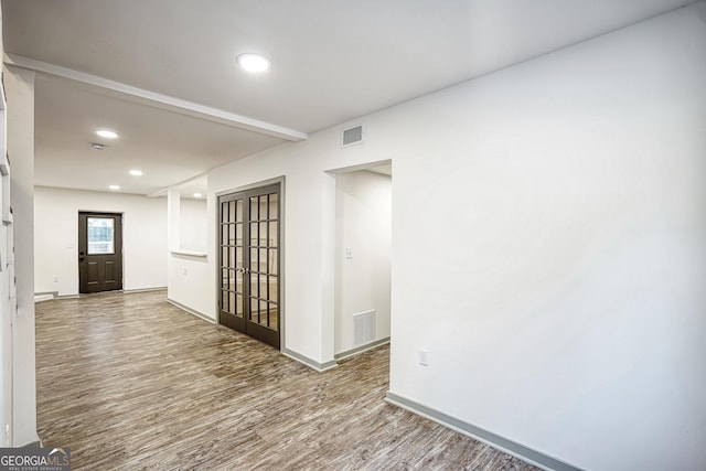 unfurnished room featuring french doors and wood-type flooring