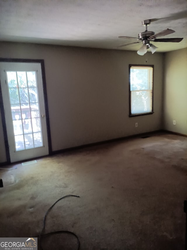 unfurnished room with carpet and ceiling fan