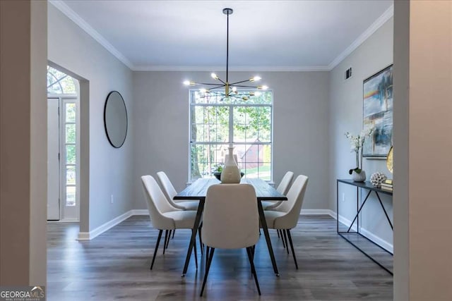 dining area with crown molding, dark wood-type flooring, and an inviting chandelier