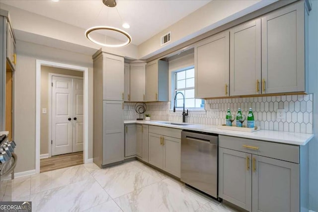 kitchen with decorative backsplash, appliances with stainless steel finishes, gray cabinets, and sink