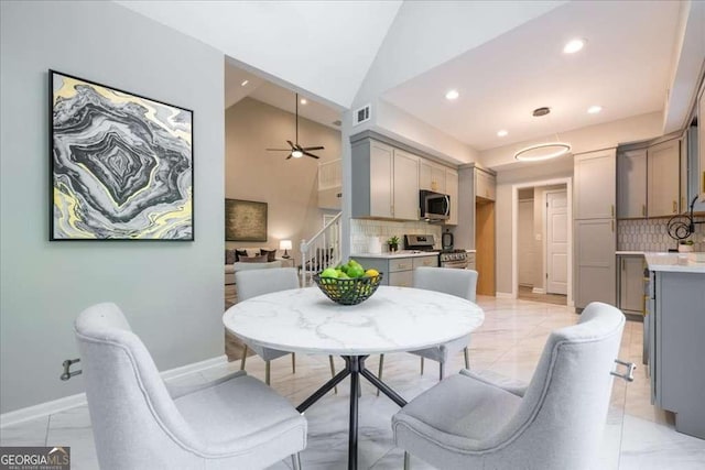 dining area featuring ceiling fan and lofted ceiling