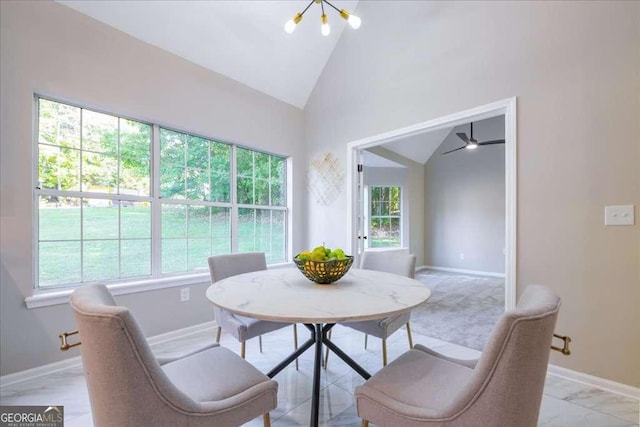 dining space featuring ceiling fan and high vaulted ceiling