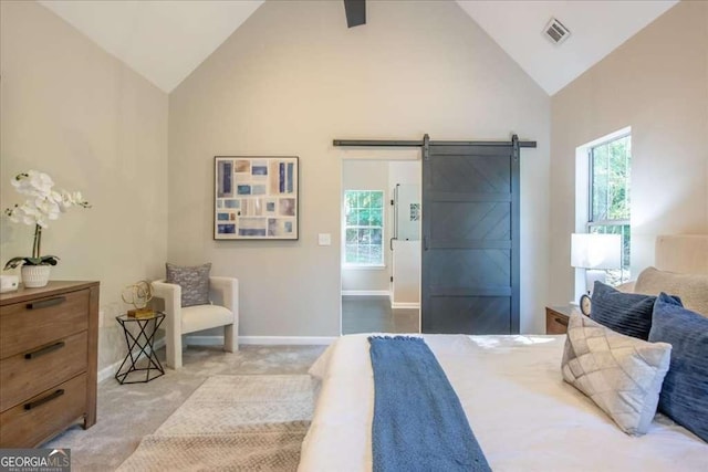 carpeted bedroom featuring ceiling fan, a barn door, and vaulted ceiling