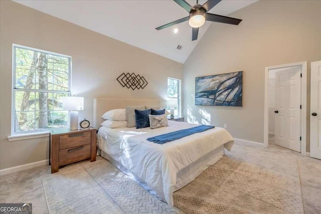 carpeted bedroom featuring multiple windows, ceiling fan, and high vaulted ceiling