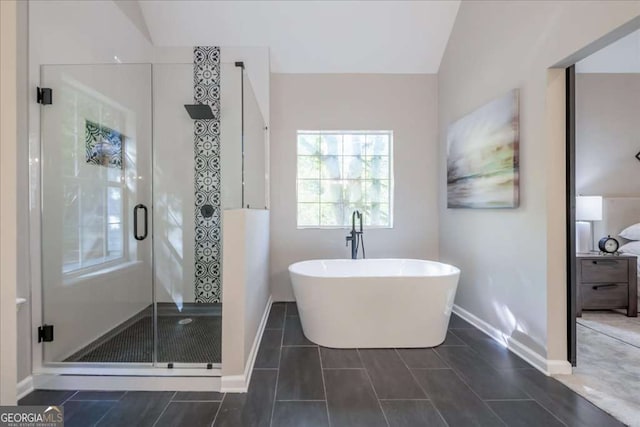 bathroom with shower with separate bathtub and vaulted ceiling