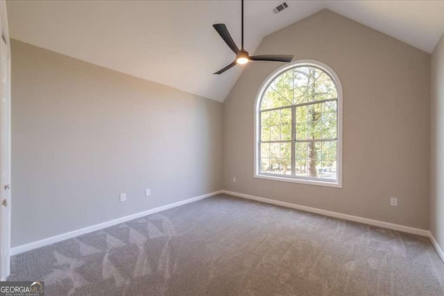 empty room featuring ceiling fan, carpet, and lofted ceiling