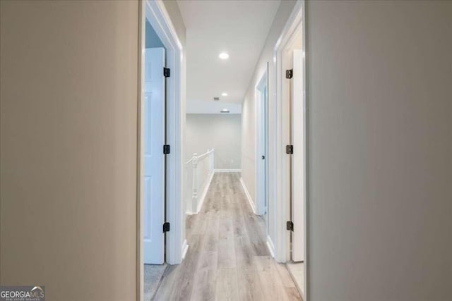 hallway with light hardwood / wood-style flooring