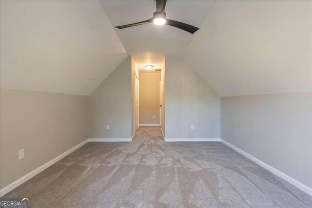 bonus room featuring ceiling fan, light colored carpet, and lofted ceiling