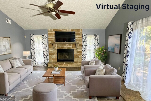 living room featuring ceiling fan, a textured ceiling, and vaulted ceiling