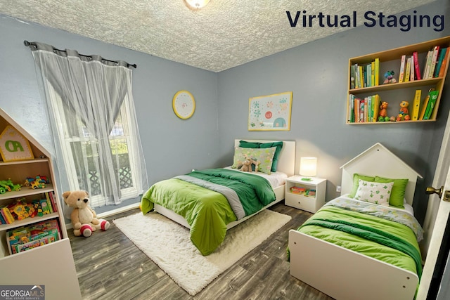 bedroom featuring a textured ceiling and dark wood-type flooring