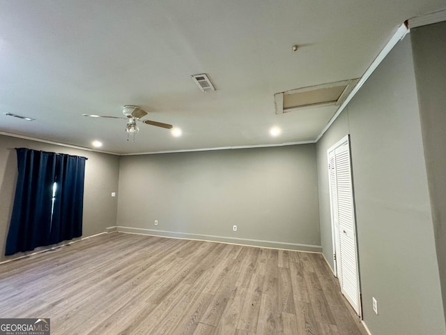 unfurnished room with ceiling fan, light wood-type flooring, and ornamental molding