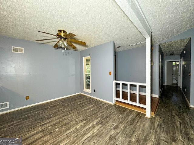 spare room featuring ceiling fan, dark hardwood / wood-style flooring, and a textured ceiling