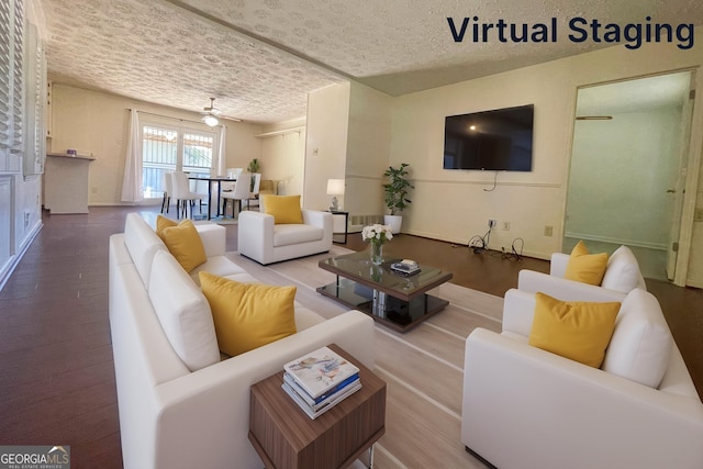 living room with ceiling fan and wood-type flooring