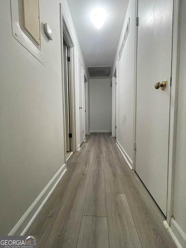 hall with light hardwood / wood-style floors