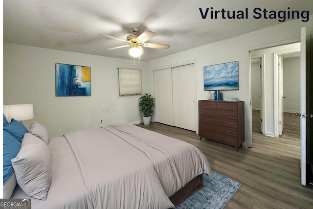 bedroom featuring ceiling fan, a closet, a textured ceiling, and hardwood / wood-style flooring