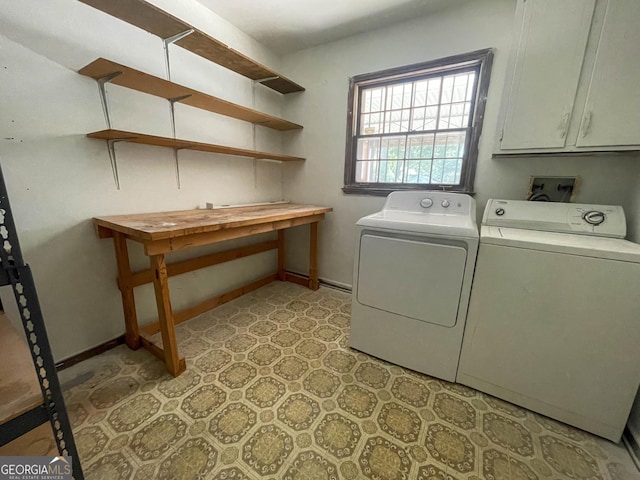 laundry room featuring washing machine and dryer and cabinets