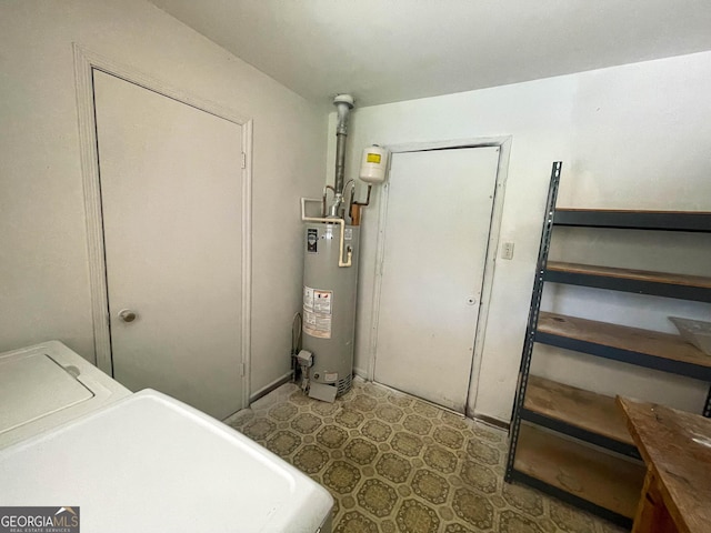 interior space with washer and clothes dryer and water heater