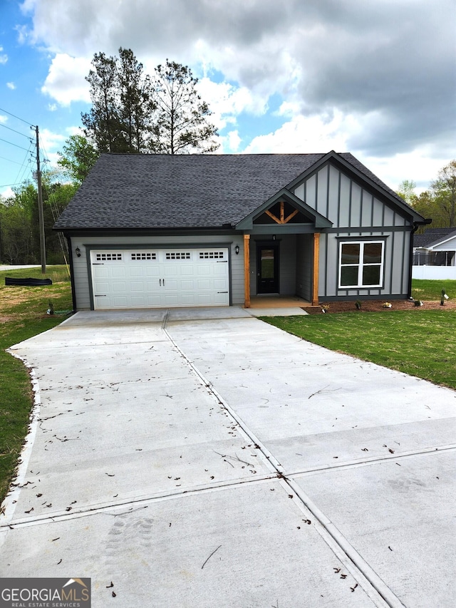 view of front of property featuring a garage and a front lawn