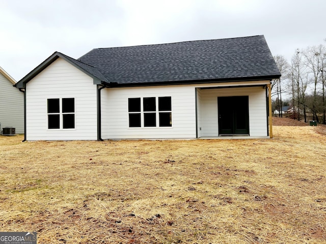 back of property featuring a lawn and central AC unit