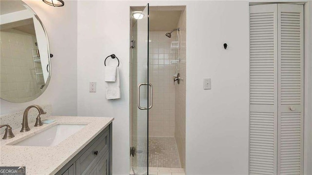 bathroom featuring vanity and an enclosed shower