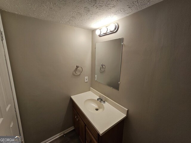 bathroom with vanity and a textured ceiling