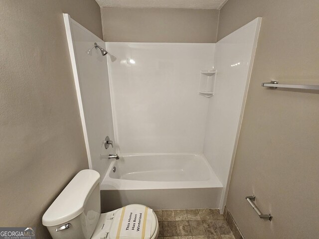 bathroom with shower / tub combination and toilet