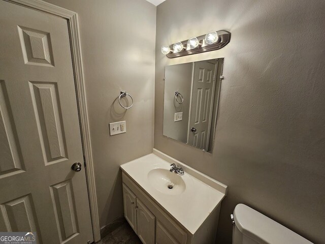 bathroom featuring vanity and toilet