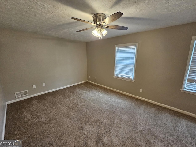 spare room featuring carpet flooring, ceiling fan, and a textured ceiling