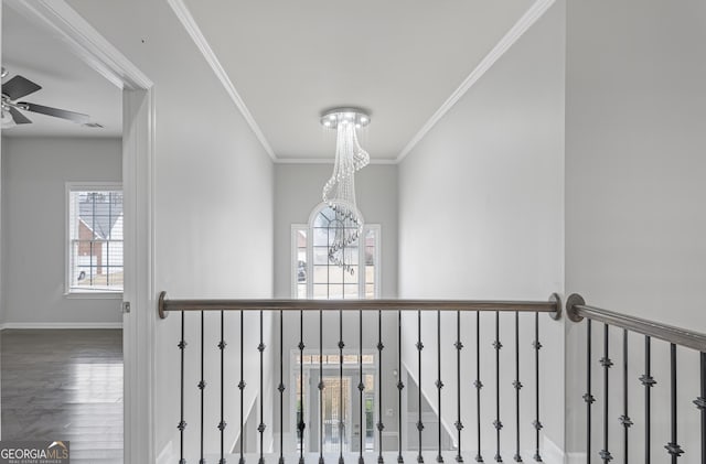 interior details with wood-type flooring, ceiling fan with notable chandelier, and ornamental molding