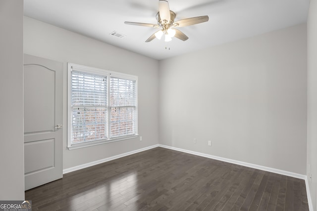 unfurnished room featuring ceiling fan and dark wood-type flooring